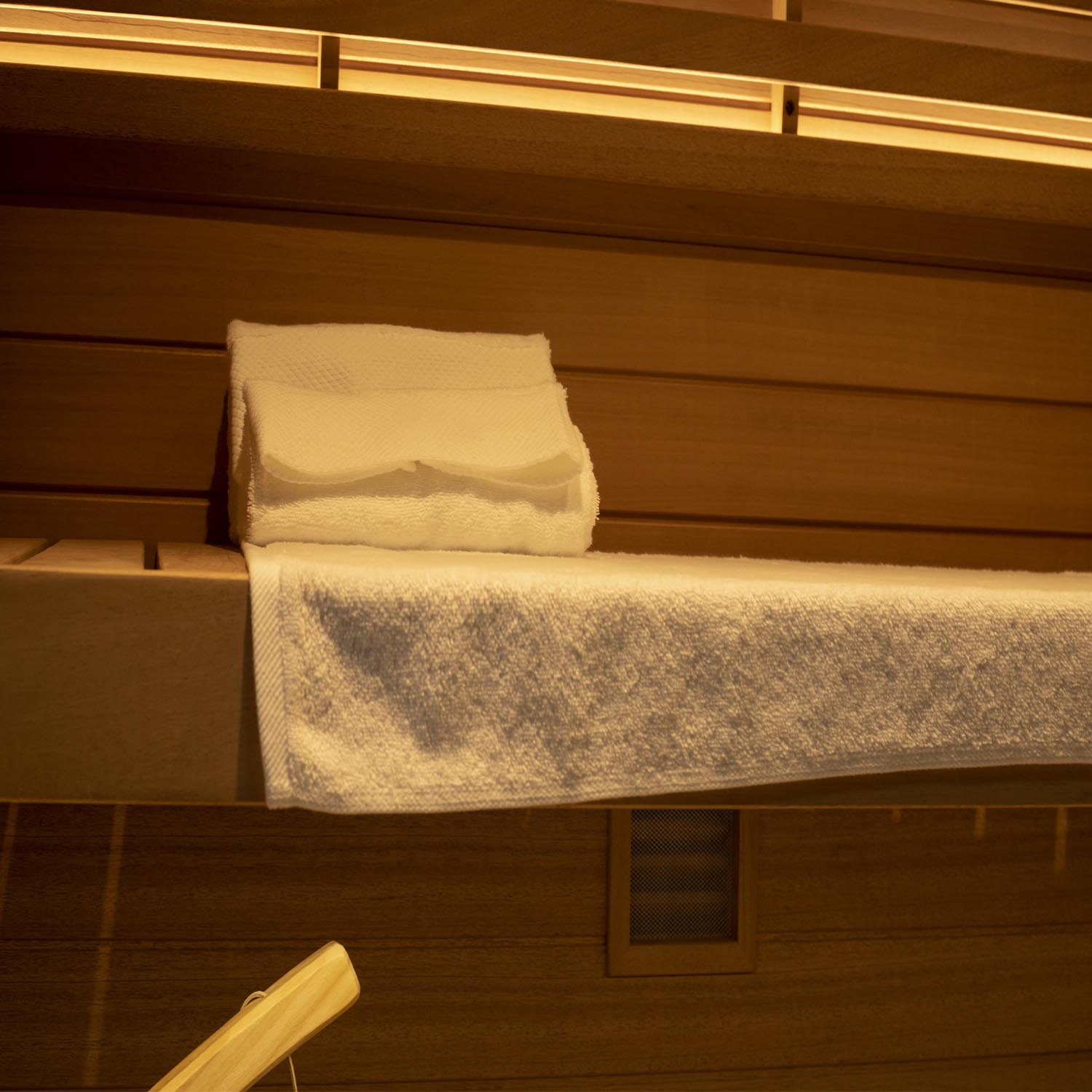 Samsora 703ST interior wellness features - African mahogany craftsmanship with therapeutic red light panels, spacious three-person bench seating and collagen-boosting ambiance