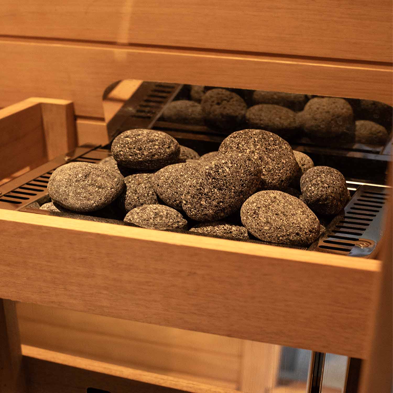 Samsora round sauna stones - natural volcanic rocks with smooth rounded shape for optimal heat retention and even steam distribution in traditional sauna heaters