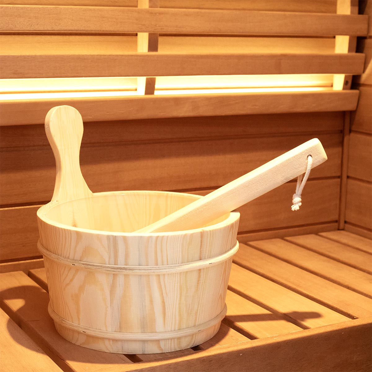 Samsora sauna bucket and ladle product display - traditional wooden accessory set featuring natural wood construction, metal band reinforcement and ergonomic ladle for authentic steam sauna water pouring ritual