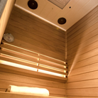 Samsora 701ST interior wellness display - African mahogany craftsmanship featuring 660nm therapeutic red light panels, ergonomic bench seating and negative ion technology for personal rejuvenation