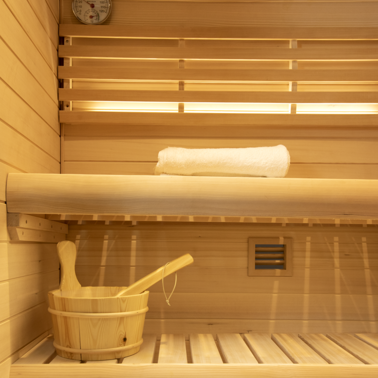  Samsora 702ST interior therapy features - African mahogany craftsmanship with therapeutic red light panels, dual bench seating and collagen-boosting ambiance for intimate wellness sessions