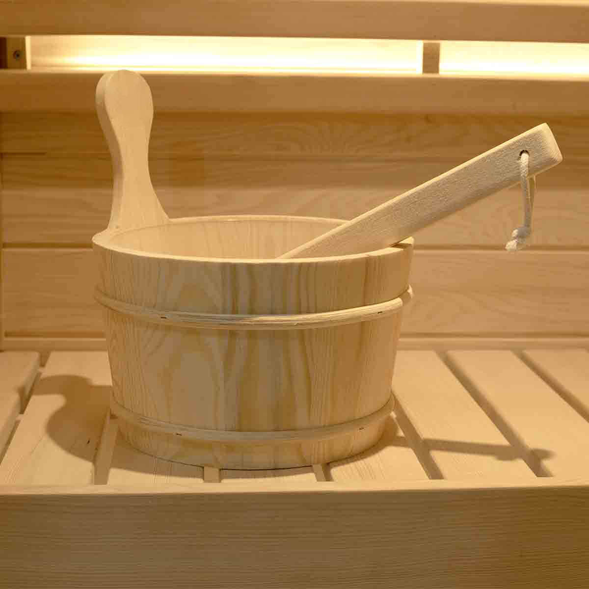 Wooden sauna bucket display - natural wood construction with metal bands for water storage and essential oil infusion during steam sessions